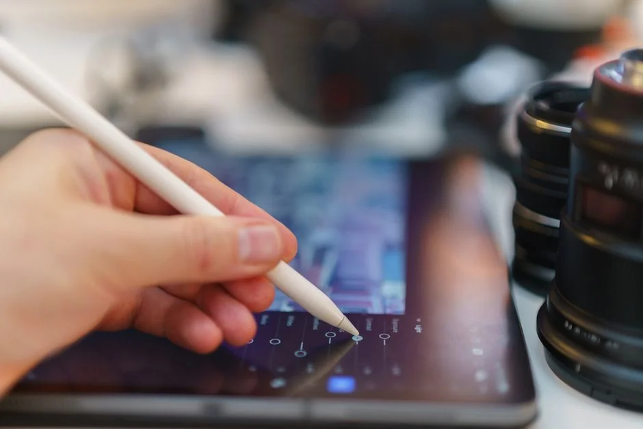 A lively workspace with a laptop, tablet, and TV, set off by vivid lighting.